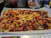 Tortilla chips, leftover taco beef, marble cheddar, fresh tomato, red pepper, yellow pepper, red onion, red kidney beans.
