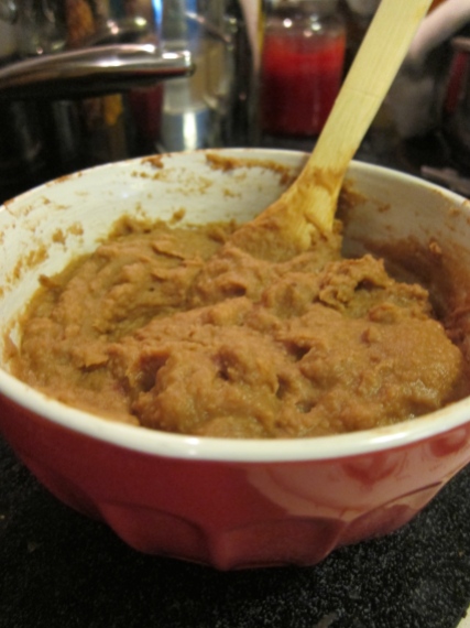 Refried beans. Consider this the base or "glue" that holds all the yummy toppings in place! (You could also use guacamole, but I prefer to add that as a topping.)