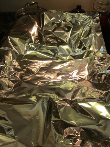 Get a big enough length of heavy duty aluminum foil. I put it into a 9 x 13 pan. No mess. No fuss.